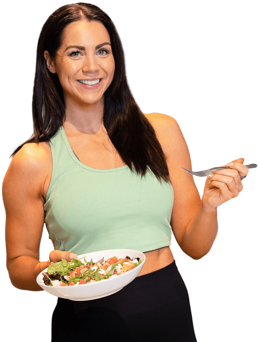 Mandy is smiling and holding a bowl of salad.
